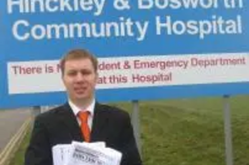 Michael Mullaney with copies of the NHS survey outside Hinckley and Bosworth Community Hospital