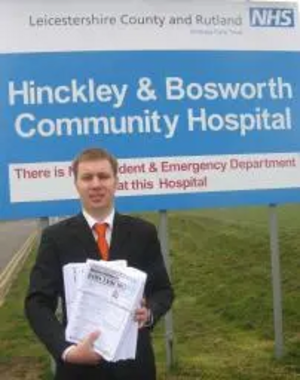 Michael Mullaney with copies of the NHS survey outside Hinckley and Bosworth Community Hospital