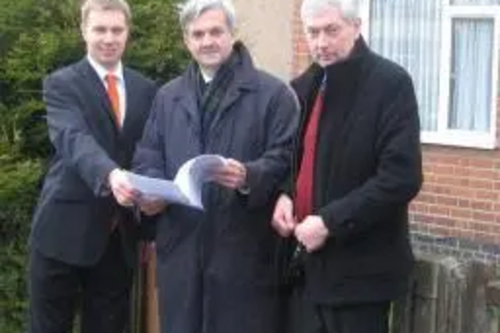 Michael Mullaney, Chris Huhne MP and Michael Gould outside the site of the planned Barwell Community House