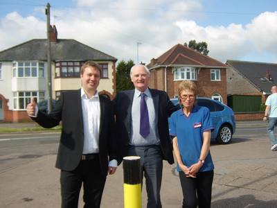 Cllrs Michael Mullaney and David Bill and a member of staff from the shop welcome the new bollards