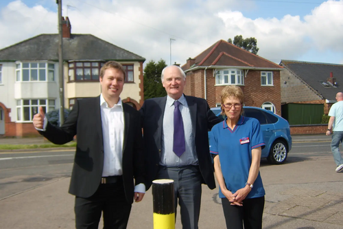 Cllrs Michael Mullaney and David Bill and a member of staff from the shop welcome the new bollards