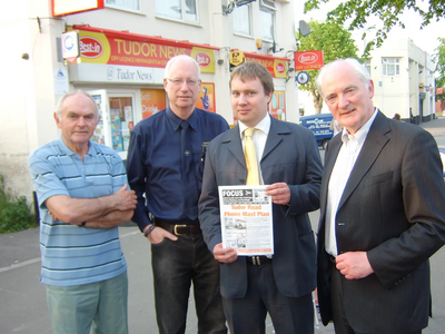 Lib Dem Councillors, David Bill, Dave Cope, Michael Mullaney and Don Wright at the site of the proposed mast on Tudor Road, Hinckley, with a copy of the petition and showing the markings where the planned mast is to go.