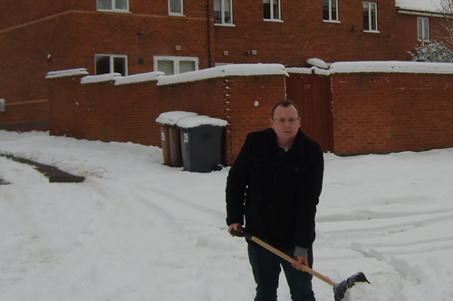  Cllr Stuart Bray lends a hand clearing streets in Hinckley