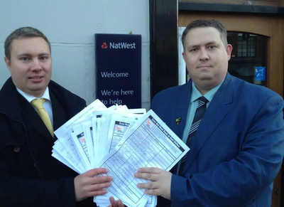 Cllrs Michael Mullaney and Mathew Hulbert with the petitions at Nat West Bank in Earl Shilton